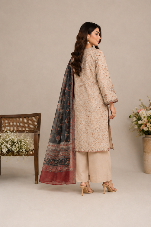 A woman modeling a traditional beige printed kurta with matching beige trousers and a dark patterned dupatta, shown from the back against a neutral studio backdrop.
