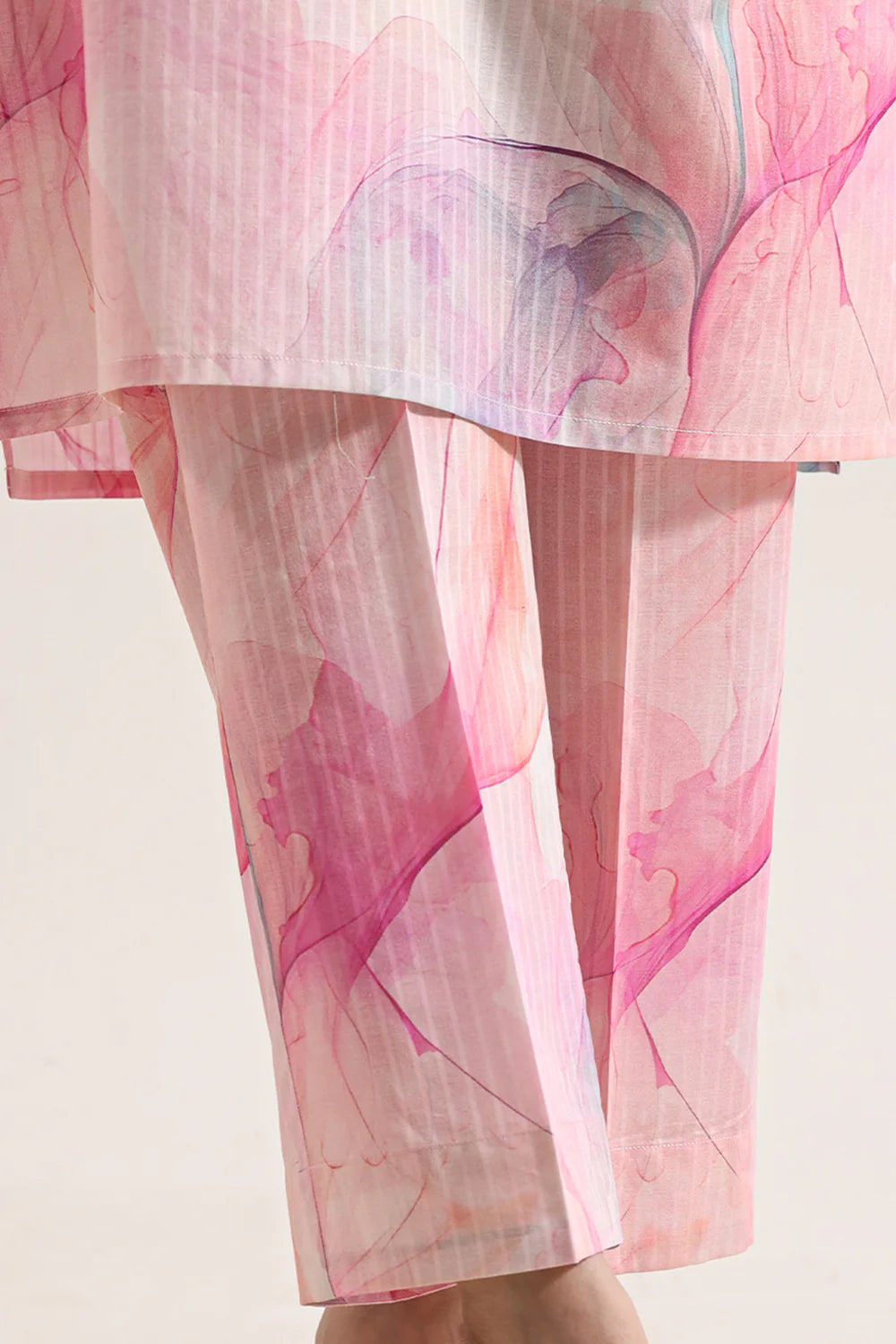 Sheer pink fabric with abstract patterns on a light background