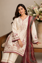A woman models a traditional South Asian salwar kameez suit set. The set features an off-white cotton kurta and matching trousers with intricate maroon and gold floral embroidery, paired with a matching maroon printed dupatta.